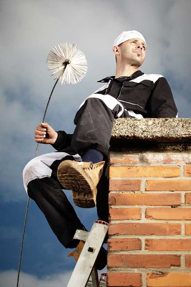 Chim Chimney Sweep Stock Image of Chimney Sweep Chimney sweep technician sitting on top brick chimney holding sweep tool