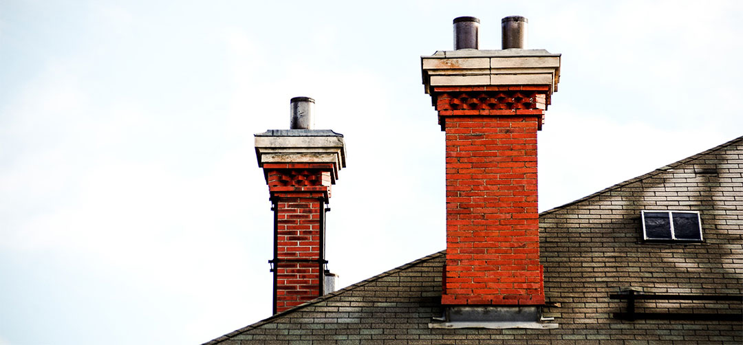 Chim Chimney Sweep Stock Image Chimneys Needing Chimney Crown and Chase Cover Repairs two chimneys with damaged masonry, rusted chase covers, and weathered chimney caps