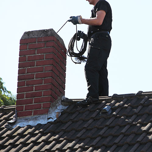 chimney sweep technician performing inspection - Chimney Inspections