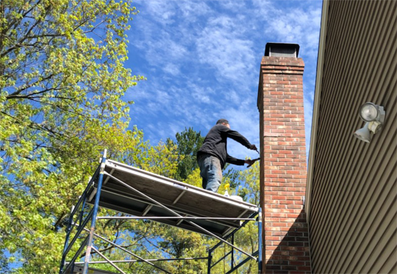 Technician Inspecting Fireplace