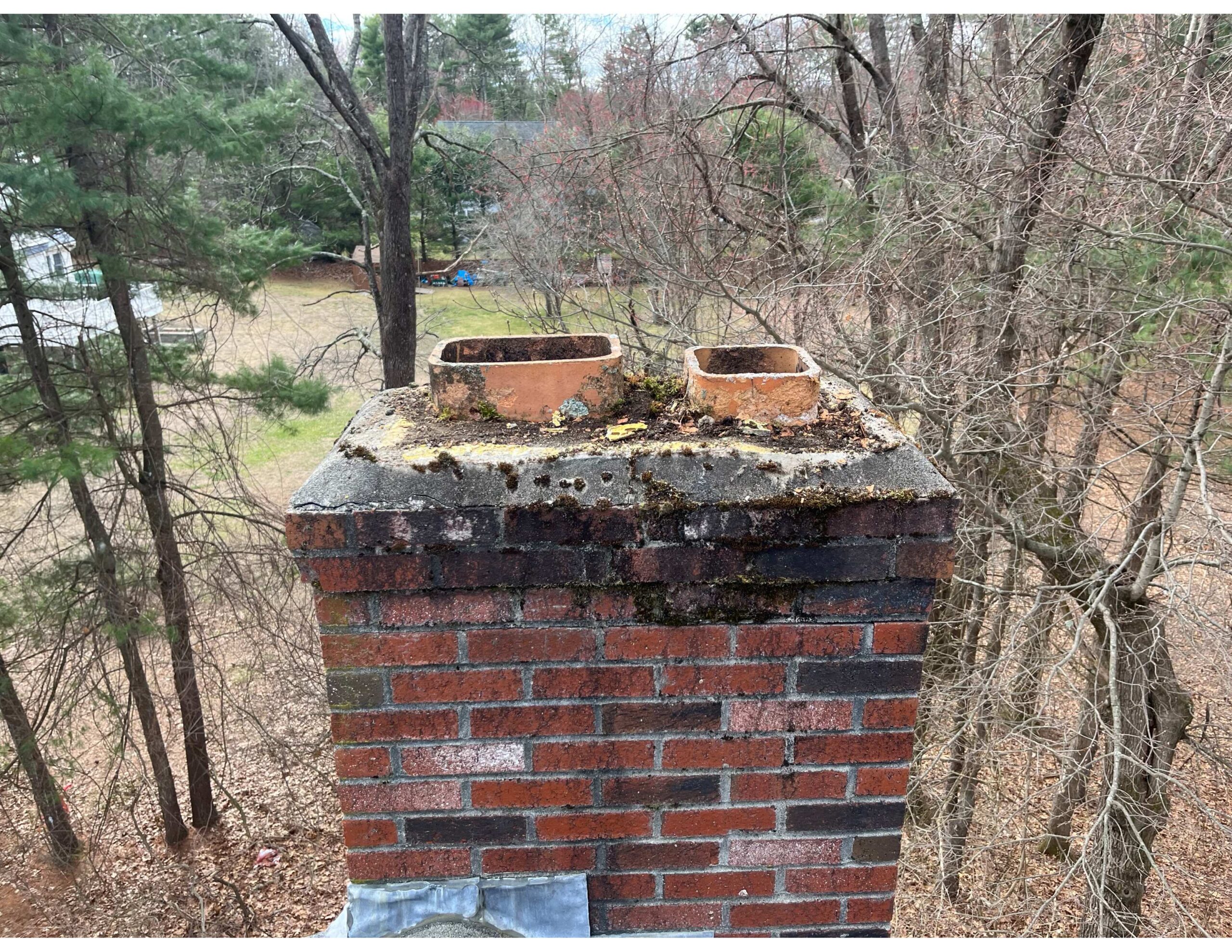 Original before photo of a chimney that was cleared of moss by Chim Chimney Sweep.