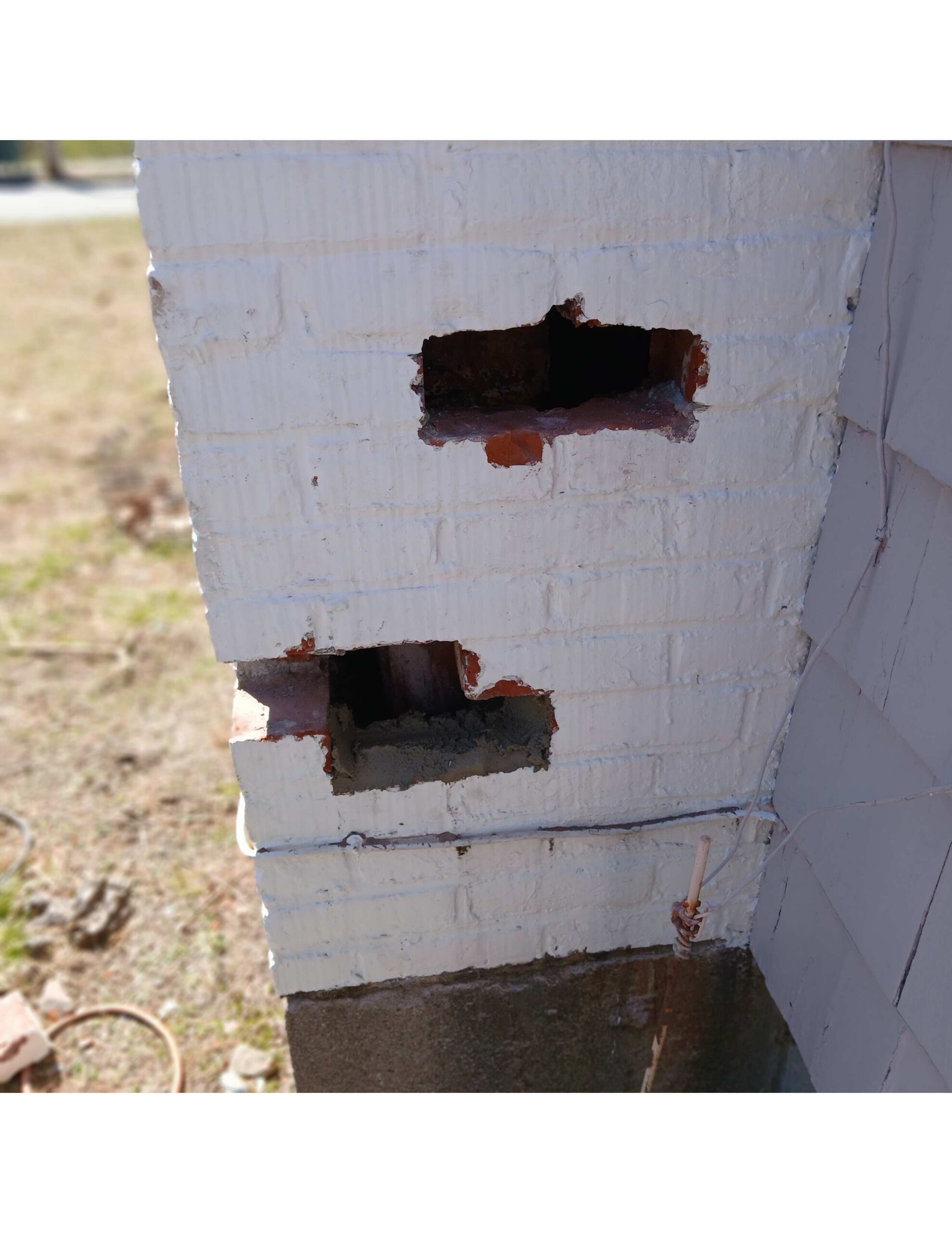 Original image of a chimney that has missing bricks for animals to enter.