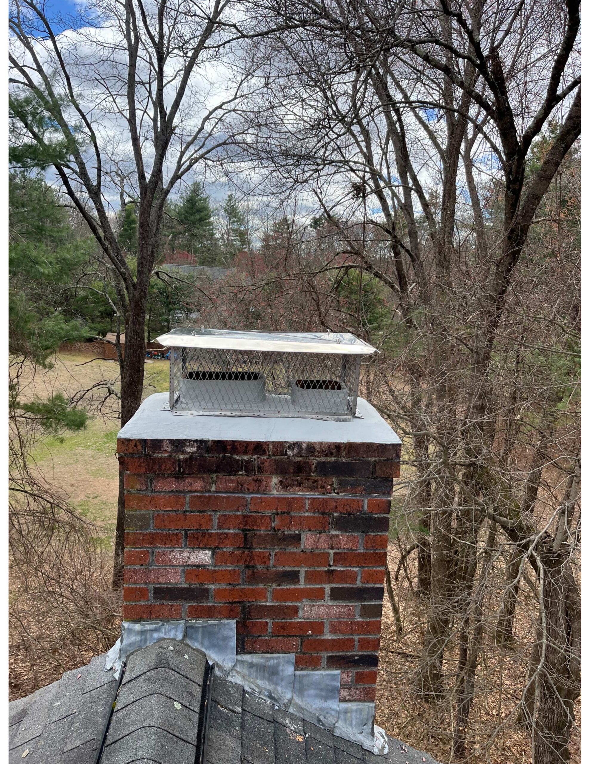 Original photo of a chimney that was cleared of moss by Chim Chimney Sweep.